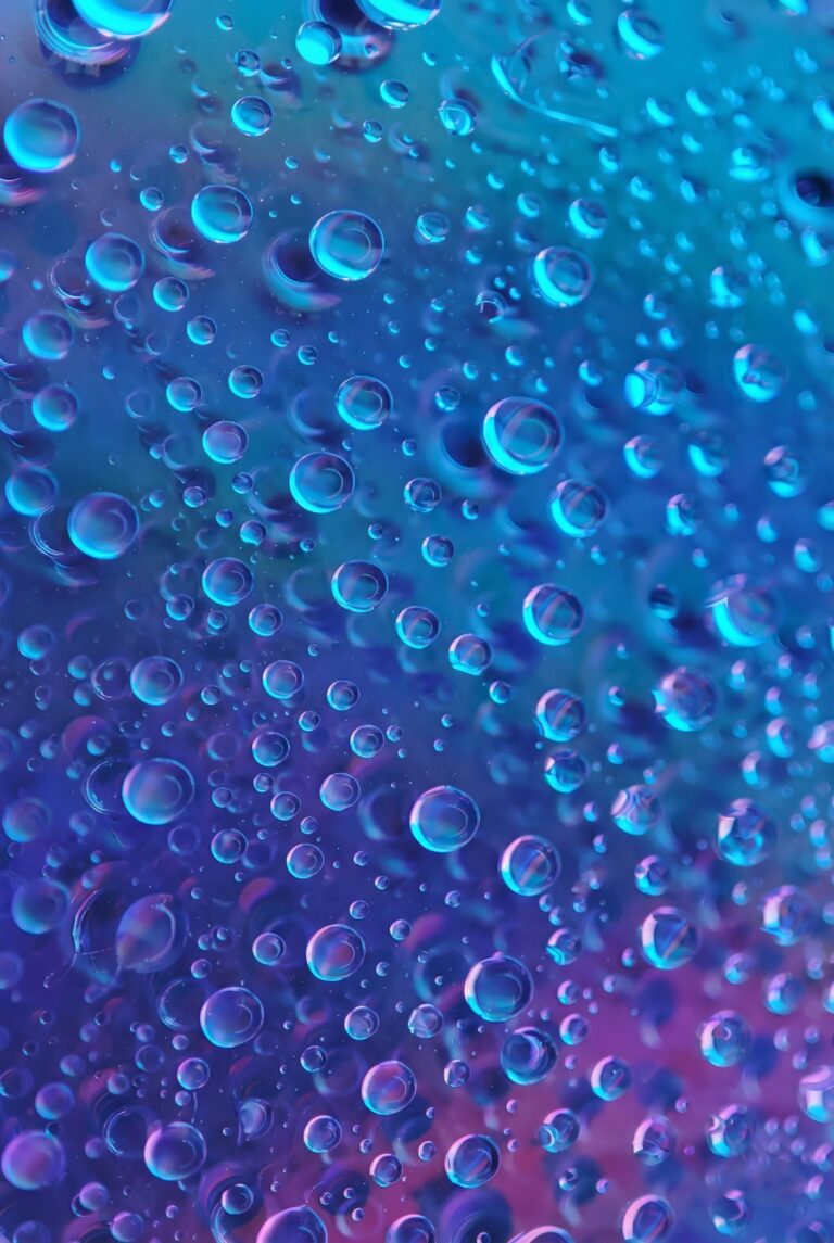 Close up macro photography of water drops on a vibrant blue and purple neon background aesthetic 4K ultra HD mobile wallpaper