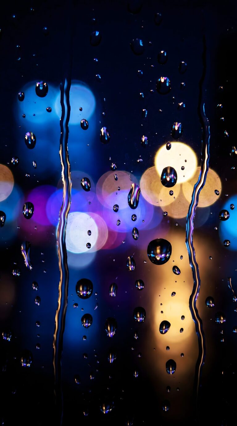 Close up macro shot of raindrops on glass with colorful glowing city bokeh lights in the background aesthetic 4K ultra HD mobile wallpaper