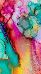 Vibrant abstract alcohol ink painting with pink, blue, and gold marble textures for mobile background