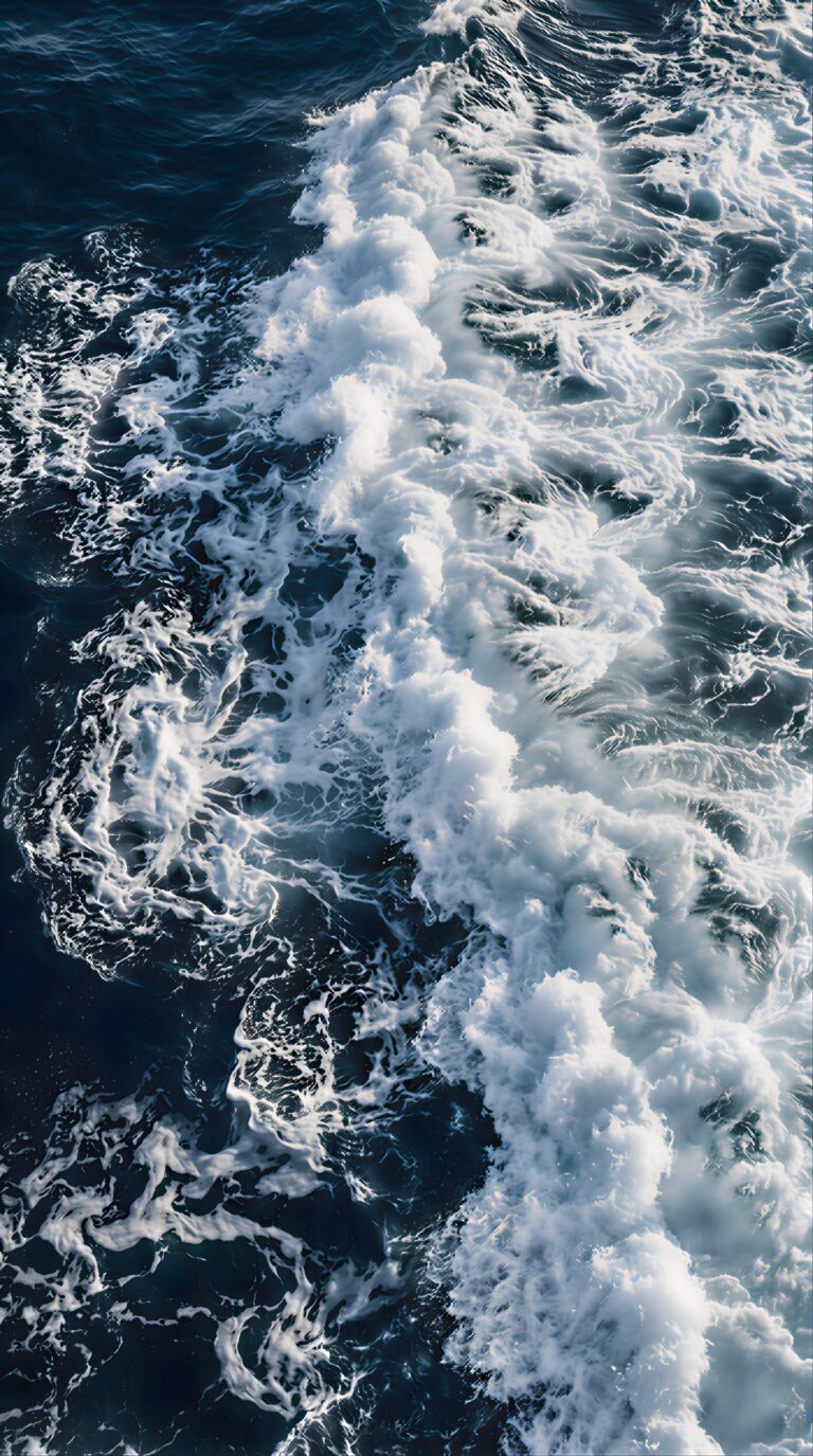 Cinematic aerial view of deep blue ocean waves and crashing white sea foam aesthetic 4K ultra HD mobile wallpaper