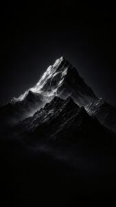 Vertical black and white nature photography of a sharp majestic mountain peak (resembling Himalayas), dramatic sunlight hitting the snowy ridges, pitch black sky background, high contrast Ansel Adams style aesthetic 4K wallpaper