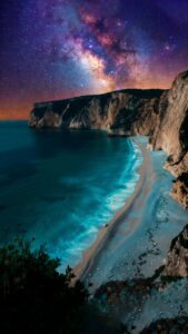 Vertical night landscape photography of a secluded beach cove with towering cliffs, turquoise glowing waves crashing on white sand, vast starry sky with the Milky Way galaxy in vibrant purple and orange colors, breathtaking nature aesthetic 4K wallpaper