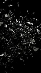 Vertical abstract 3D digital art of shattered black glass and obsidian fragments exploding against a pitch-black background, sharp silver reflections, dark AMOLED 4K aesthetic