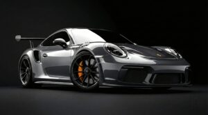 Horizontal studio photography of a metallic silver Porsche 911 GT3 RS sports car, black wheels with yellow brake calipers, dark black background, cinematic lighting, 4K automotive wallpaper