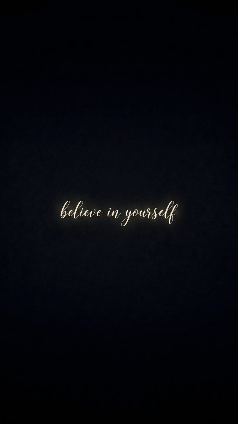 Highly detailed digital art featuring a glowing believe in yourself motivational quote in cursive text on a pure black background aesthetic 4K ultra HD mobile wallpaper