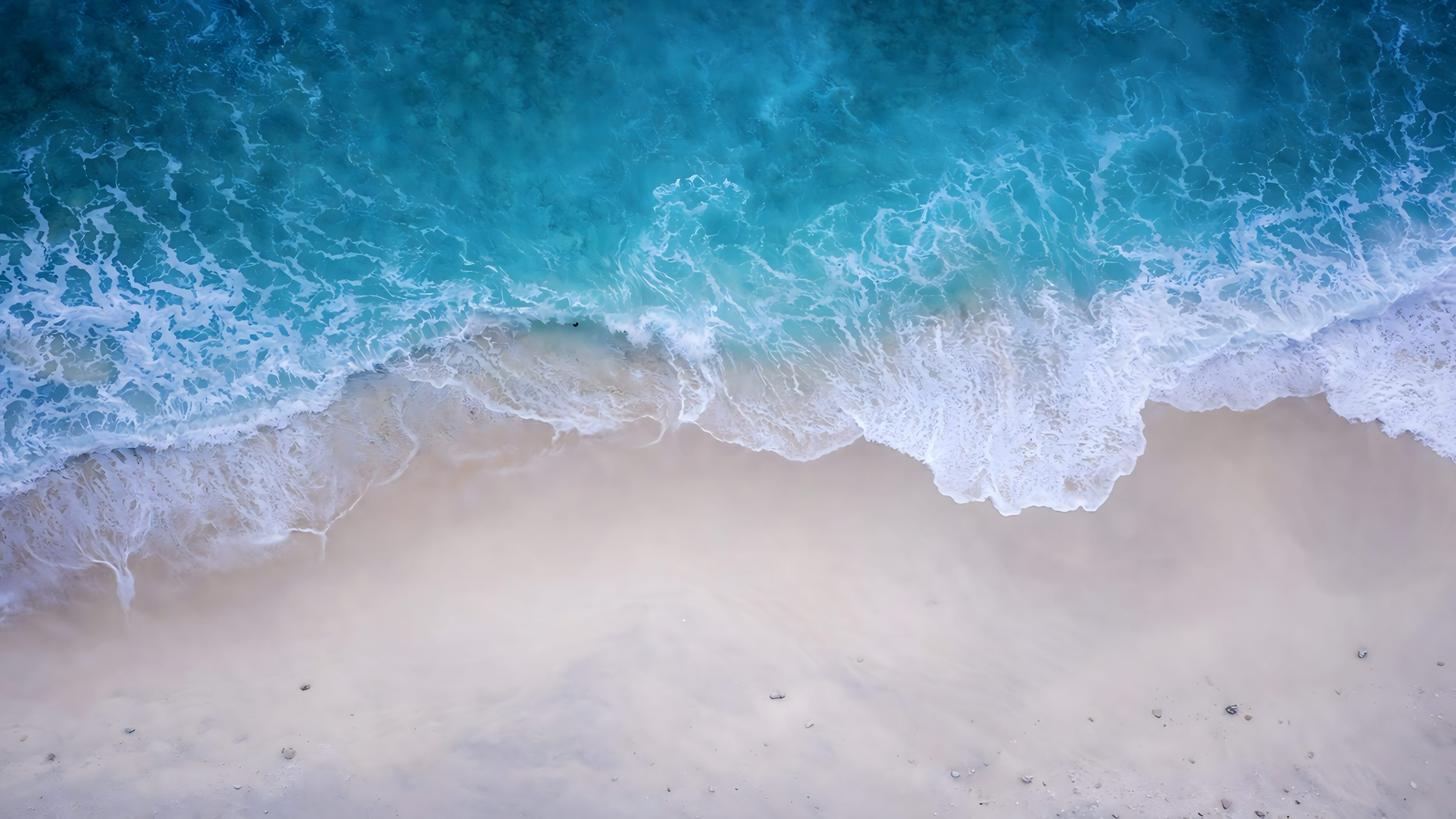Highly detailed 4K aerial drone photography of beautiful turquoise blue ocean waves crashing on a pristine white sand beach, optimized as a cool desktop wallpaper.