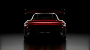 Dark Red Porsche GT3 RS AMOLED Wallpaper 4K, cinematic rear view of a dark red sports car with glowing red taillights and a massive rear wing on a pitch-black background.