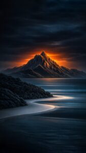 Sharp 4K mobile wallpaper of a majestic mountain glowing under a dark sunset sky with a smooth beach and ocean.