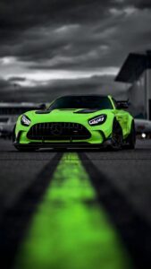Highly detailed digital render of a sleek neon green Mercedes AMG supercar parked on a race track with a glowing green leading line under a dark moody cloudy sky aesthetic 4K ultra HD mobile wallpaper