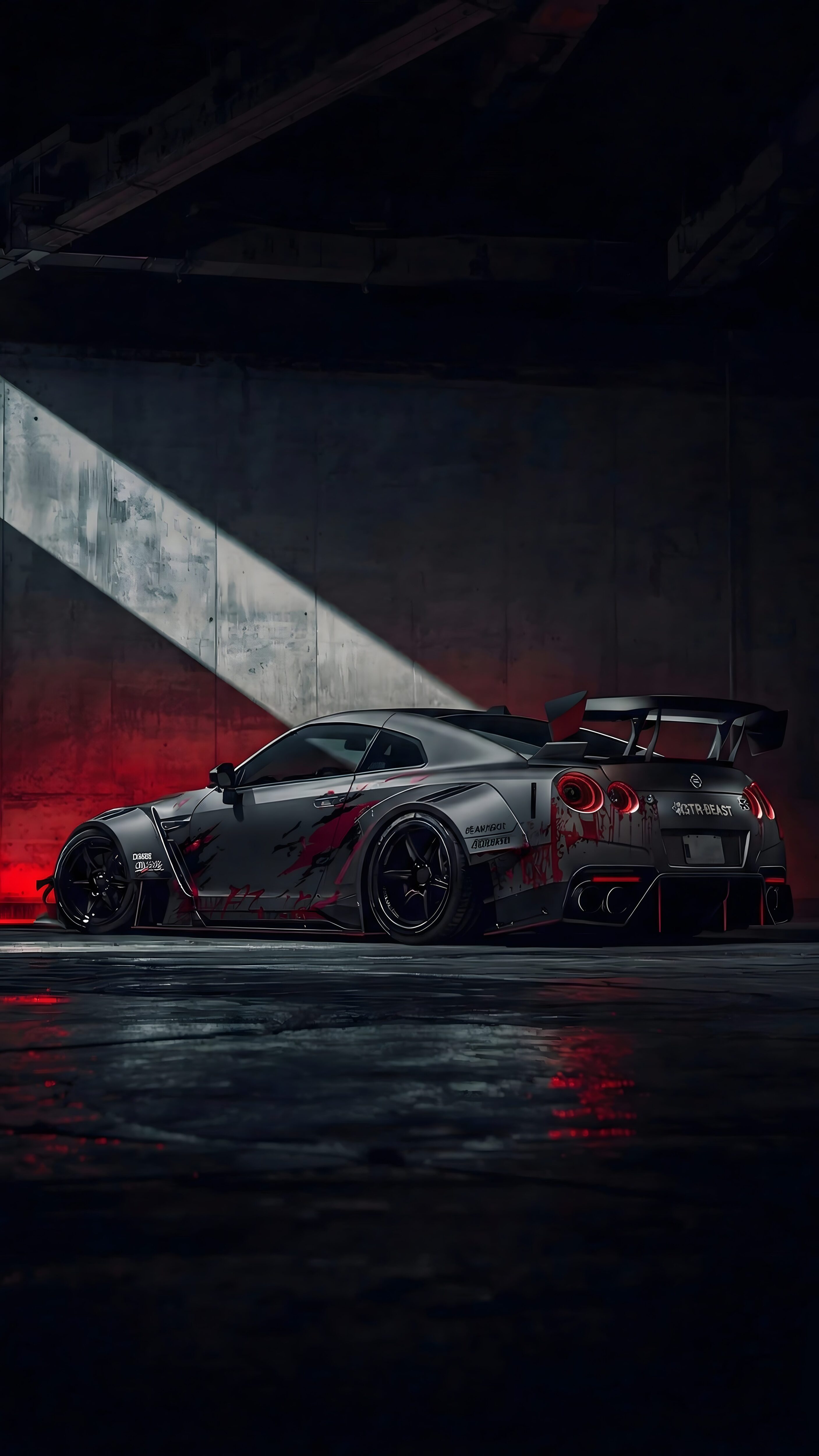 Download free 4K mobile wallpaper of a custom widebody Nissan GT-R R35 parked in a dark industrial garage with red accents and a sharp spotlight effect.
