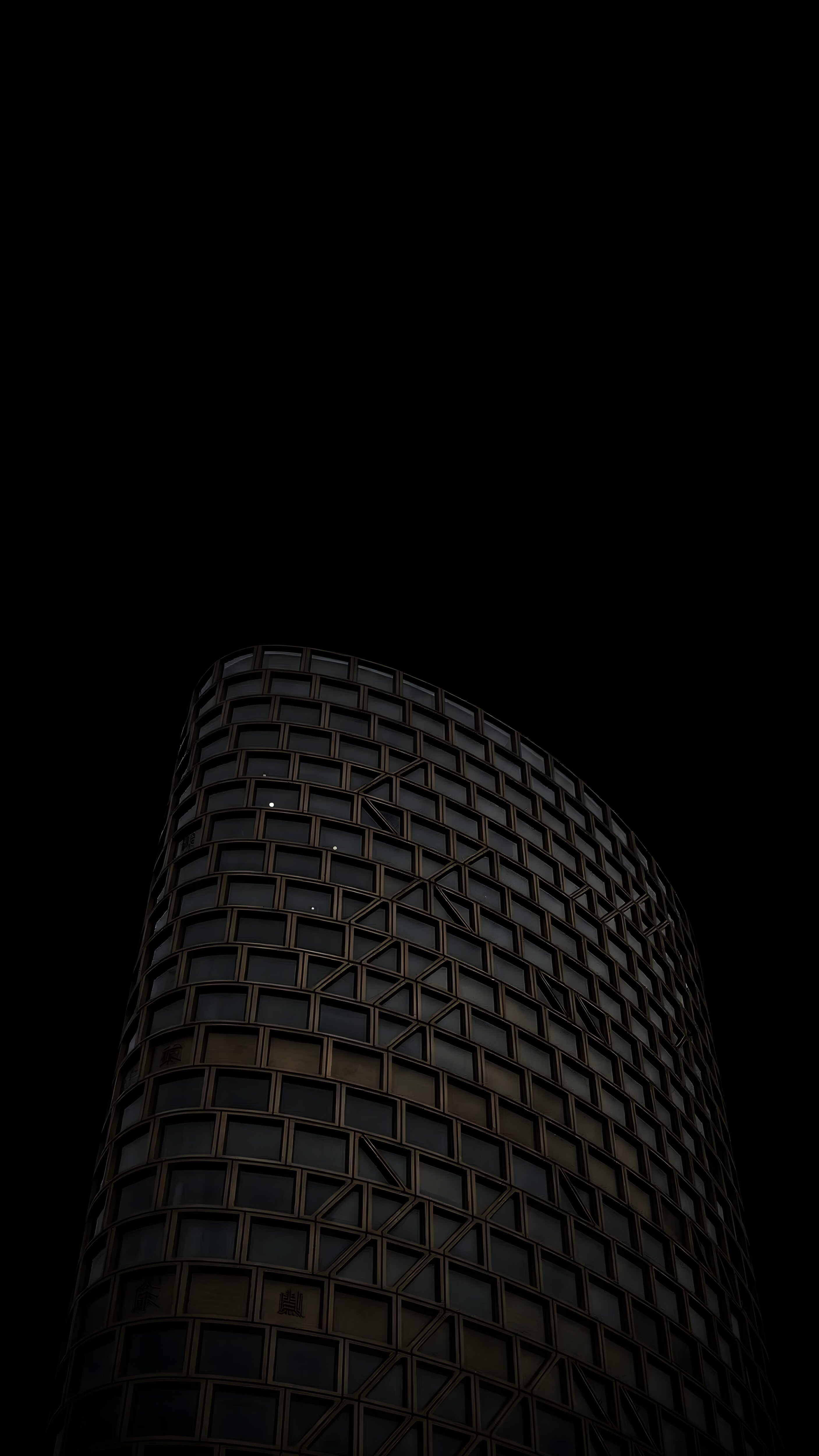 Modern skyscraper with geometric window patterns on a pitch-black 4K AMOLED mobile wallpaper.