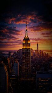 A vertical background showing the Empire State Building in New York City glowing under a dramatic orange and purple sunset sky.