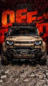 Muddy Land Rover Defender 4K mobile wallpaper with off-road orange background and rugged tires.