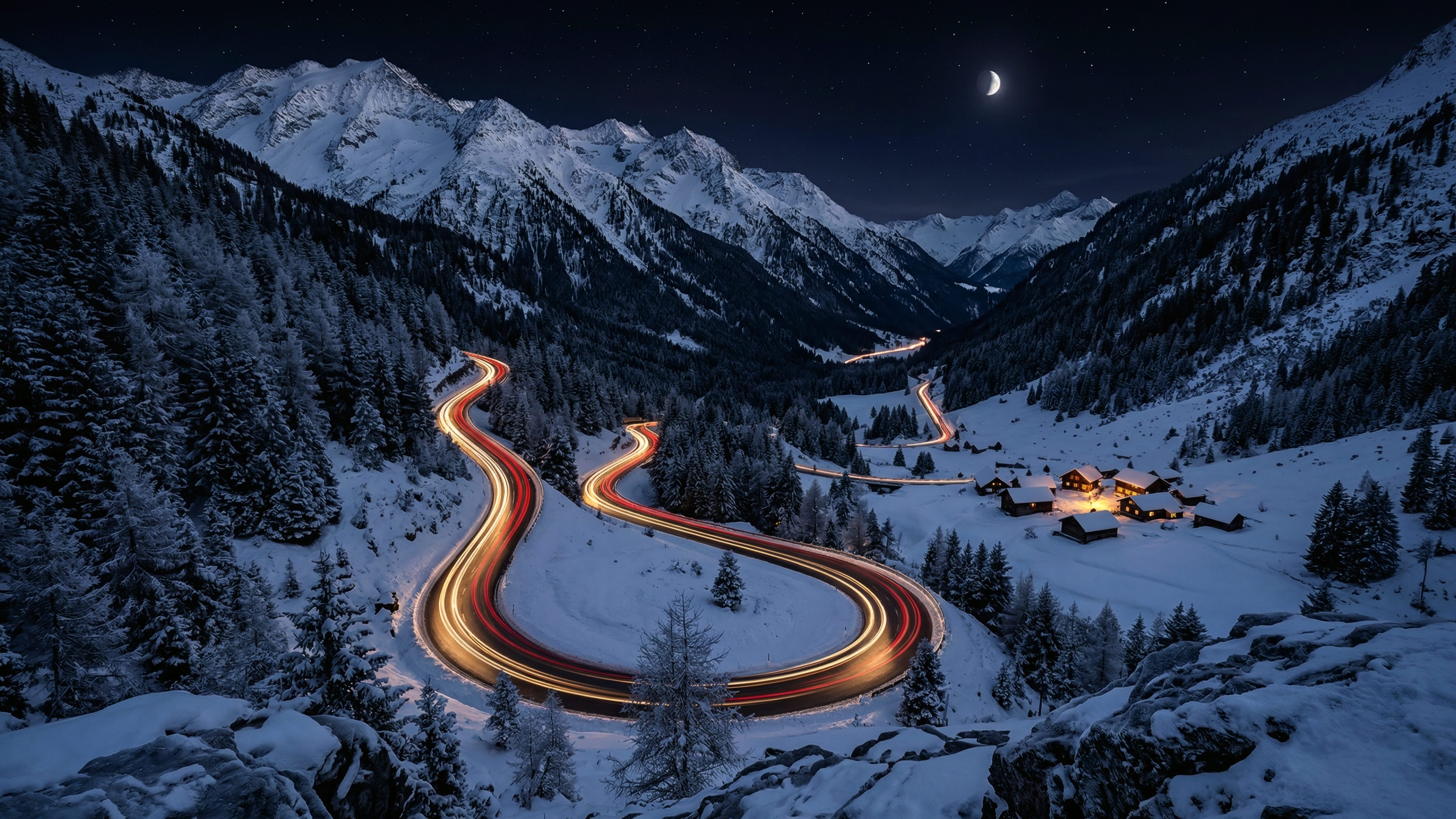 A high-resolution 4K desktop wallpaper featuring long exposure red and gold light trails winding through a snowy mountain valley at night with a glowing village.