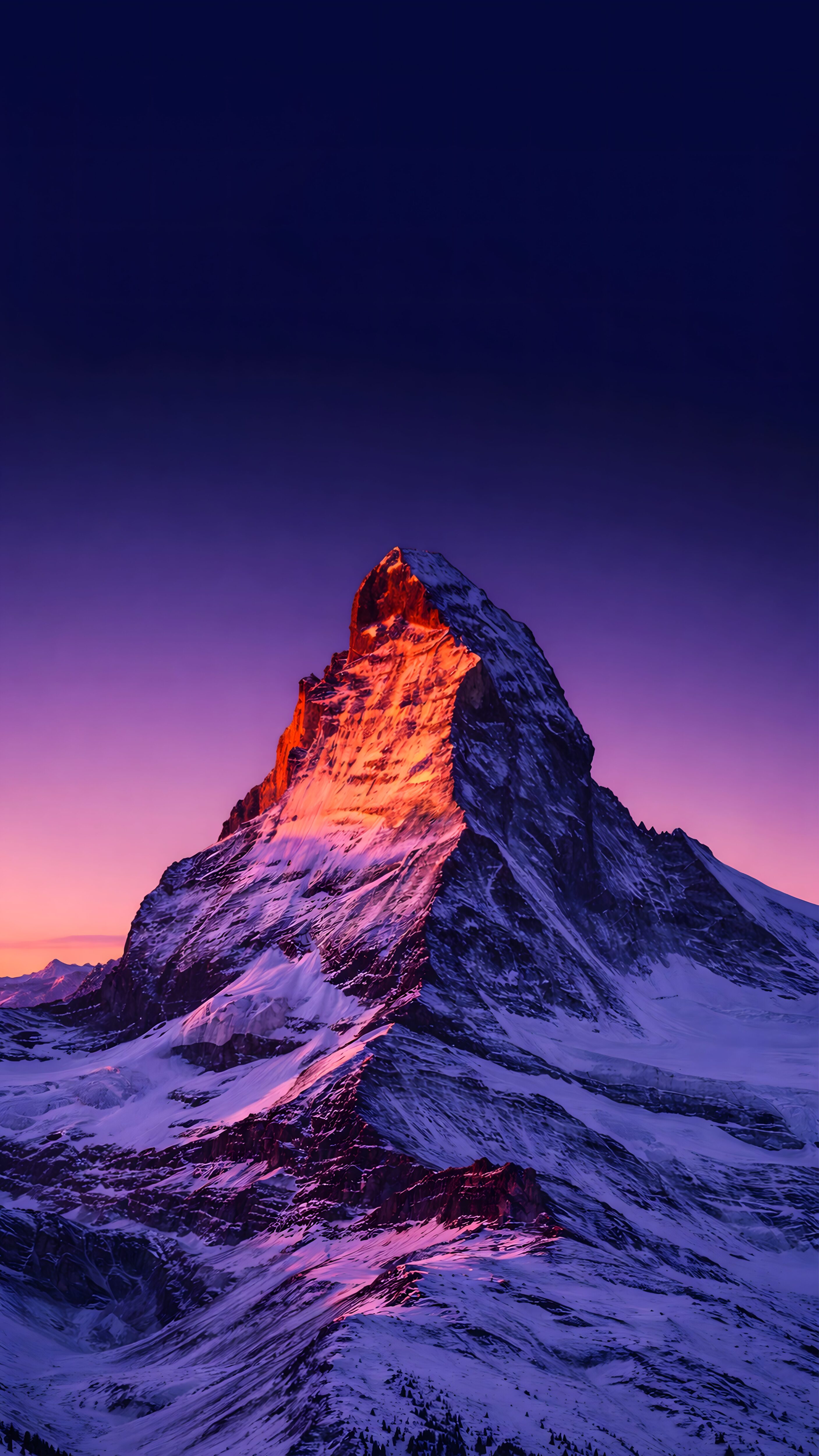 4K mobile wallpaper of a snow-covered mountain peak under a purple sunset sky, perfectly framed for the iPhone iOS lock screen depth effect.