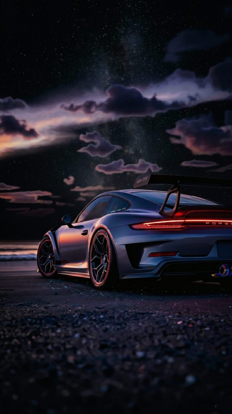 Silver Porsche sports car parked on a dark beach under a dramatic starry night sky, optimized for mobile screens.