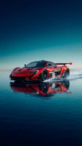 A 4K mobile wallpaper of a red McLaren P1 GTR supercar with the number 21 on the door, driving on a wet surface with a perfect reflection under a gradient blue sky.