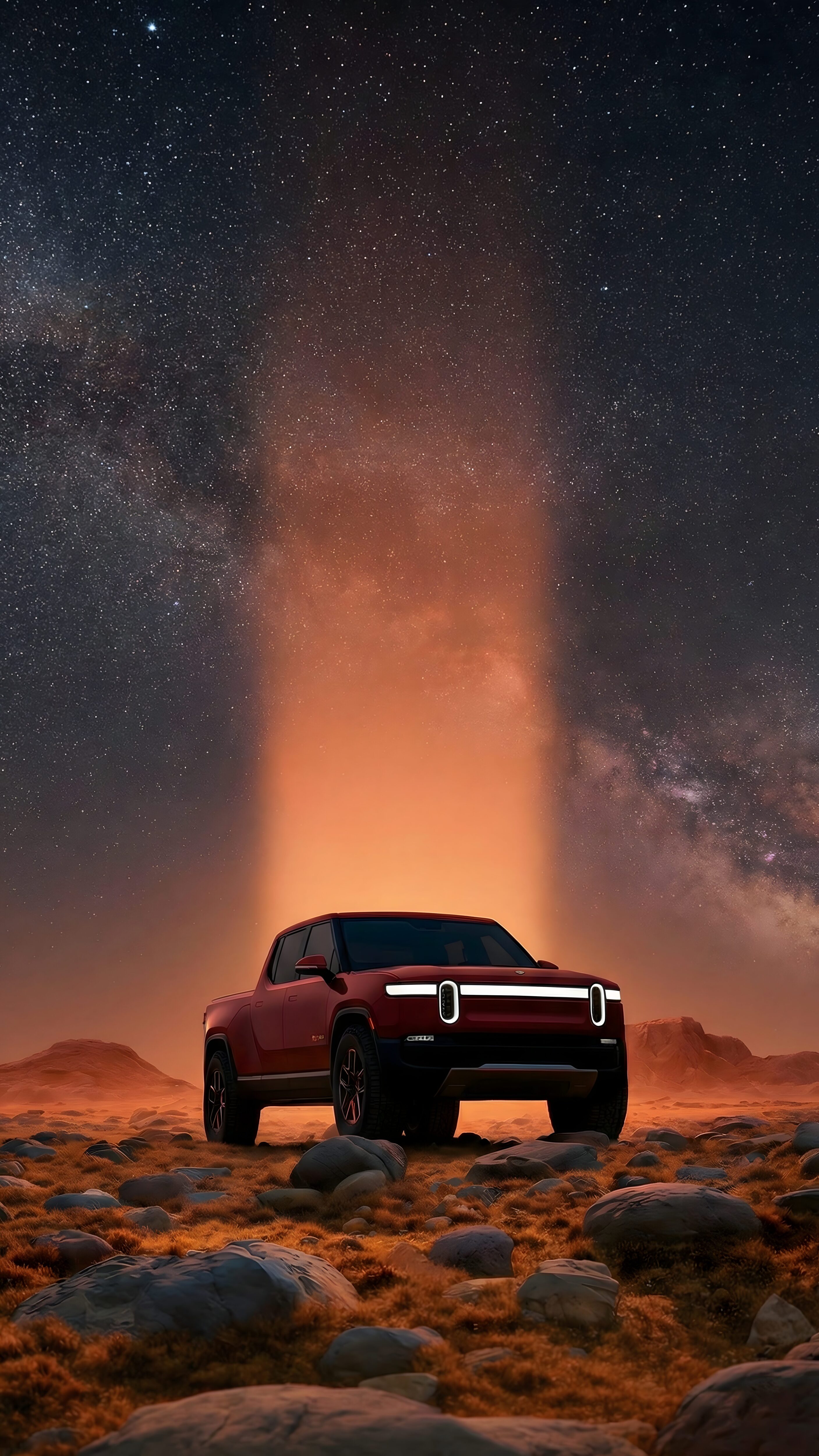 A high-resolution 4K mobile wallpaper of a red Rivian R1T electric truck parked on rocky desert terrain under a starry night sky with a bright orange light beam.