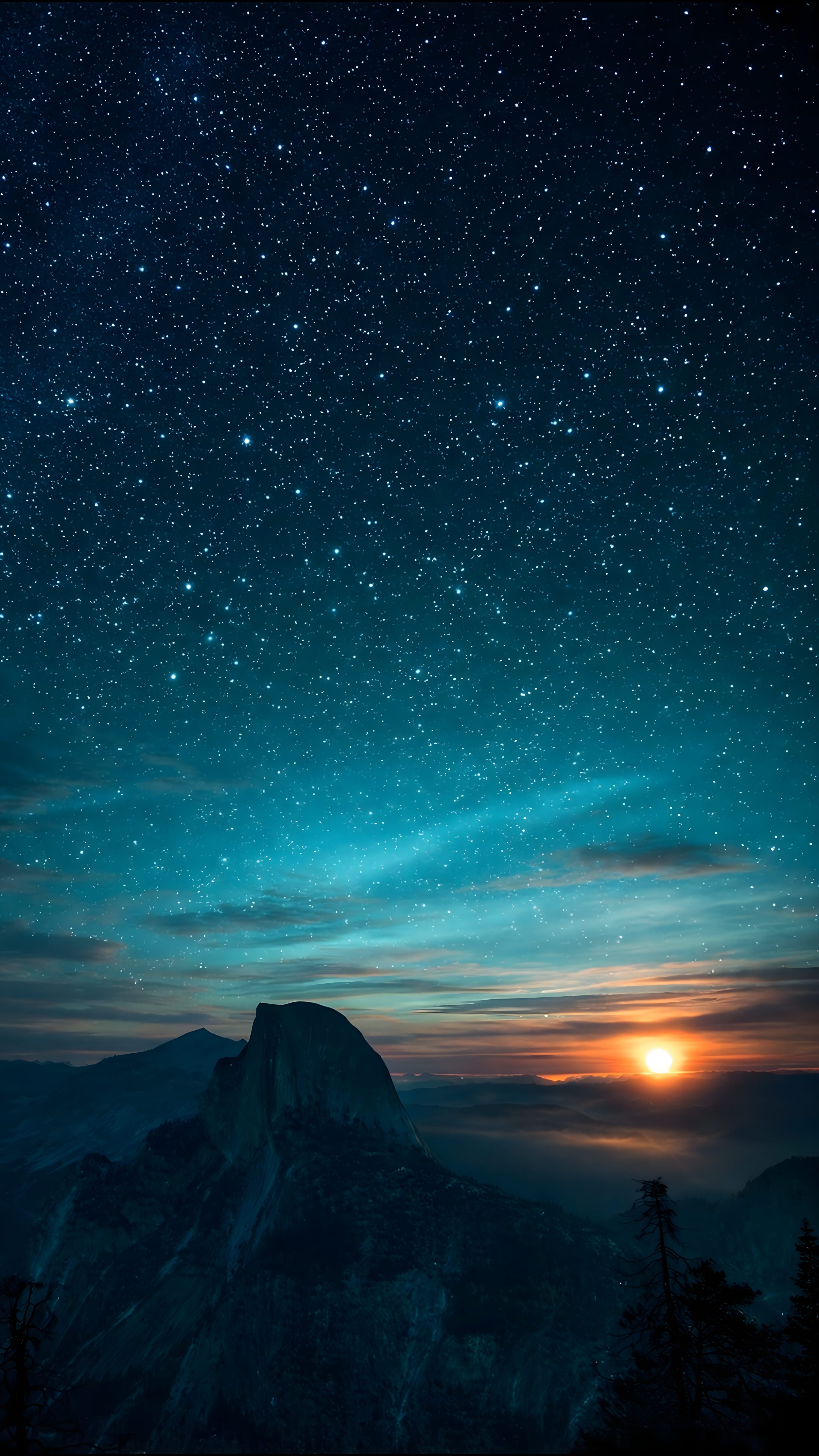 A high-resolution 4K iPhone wallpaper featuring the dark silhouette of a mountain peak against a vast starry night sky that transitions into a glowing orange sunrise.