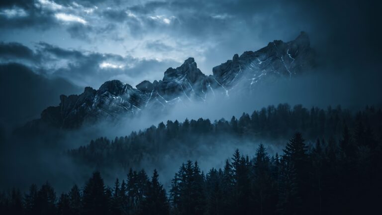 A moody mountain range with glowing blue fractures rising above a misty pine forest at twilight.