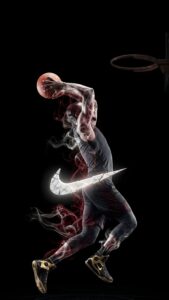 A basketball player dunking with his body transforming into smoke, featuring a shattered 3D Nike swoosh against a dark black background.