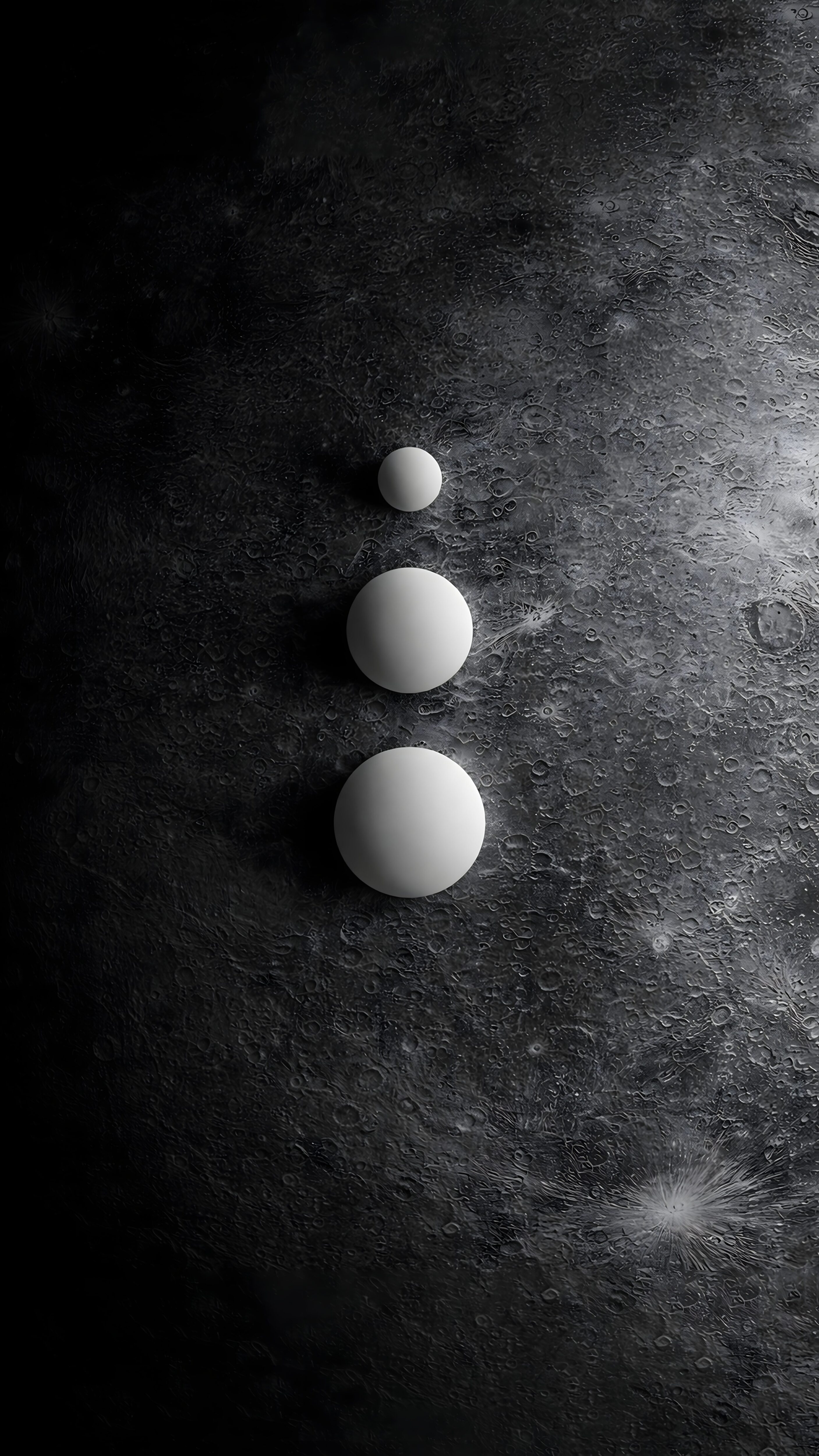 Three smooth white spheres stacked vertically by size on a dark, textured cratered lunar surface.