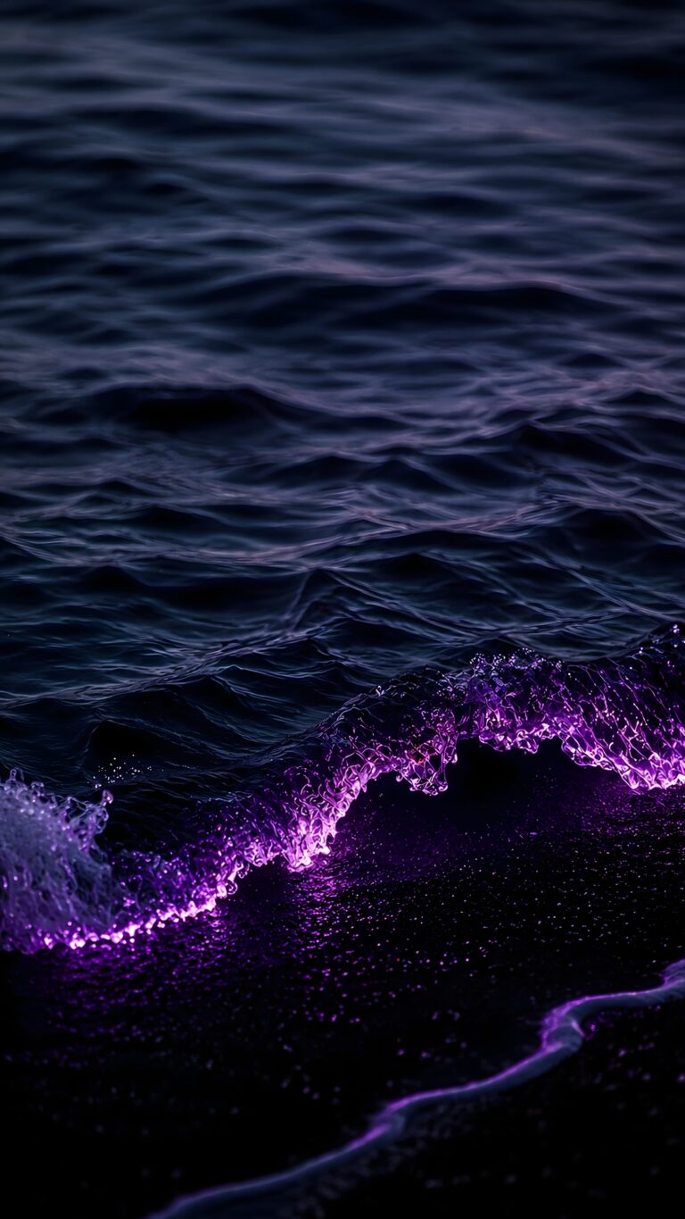 A dark ocean wave crashing onto the beach, glowing with intense bioluminescent neon purple light against the midnight water.